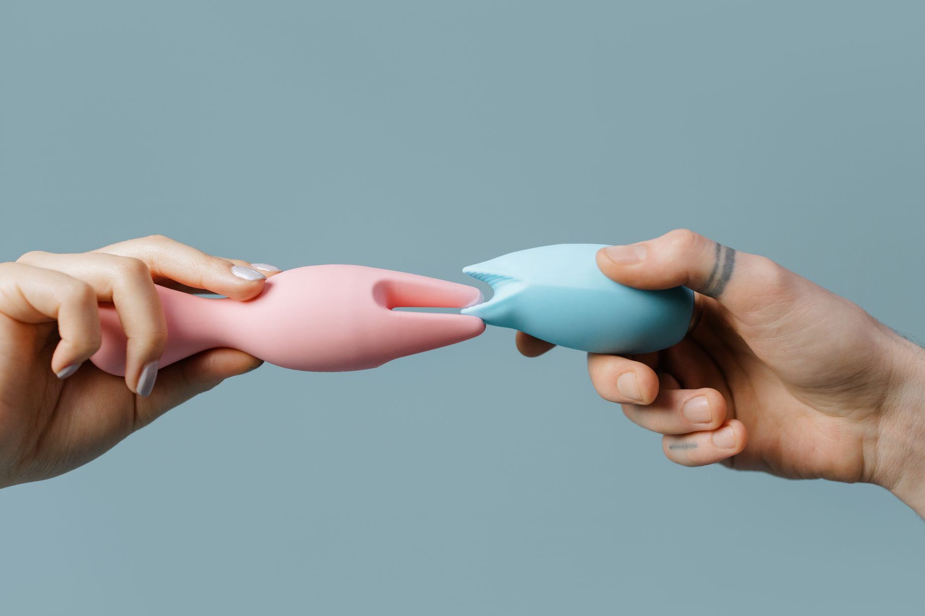 Blue vibrator surrounded by fresh citrus on bright yellow background